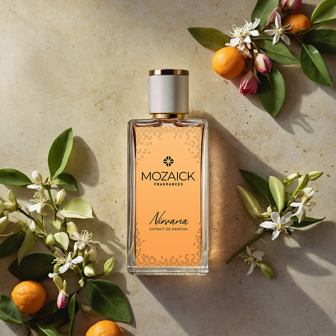 NIRVANA Extrait de Parfum 50 ml by MOZAICK – bottle on pale stone with orange branches and white blossoms